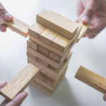 People playing Jenga - A Symbol of An Enterprise Architecture/Service Oriented Architecture – How To Mitigate Risk 